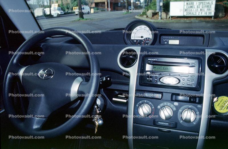 Steering Wheel, keys, radio, heating controls, knobs, dashboard