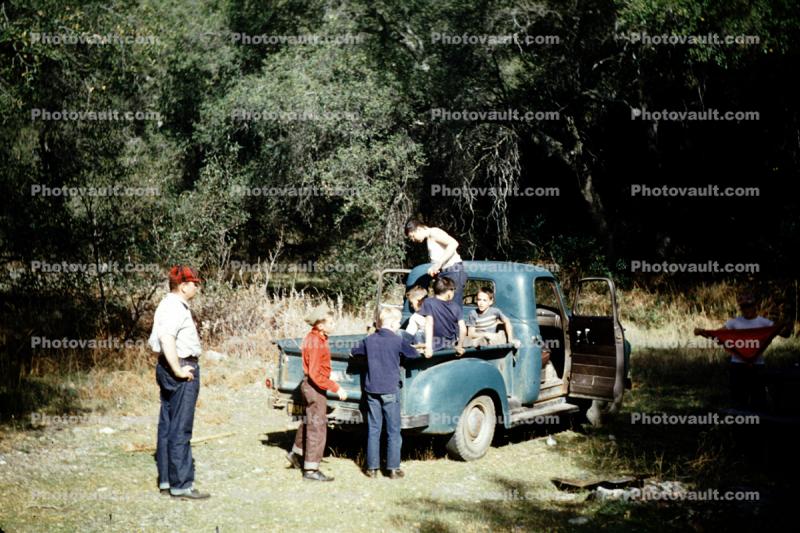 boys in the back of a pickup truck, vehicle, 1950s