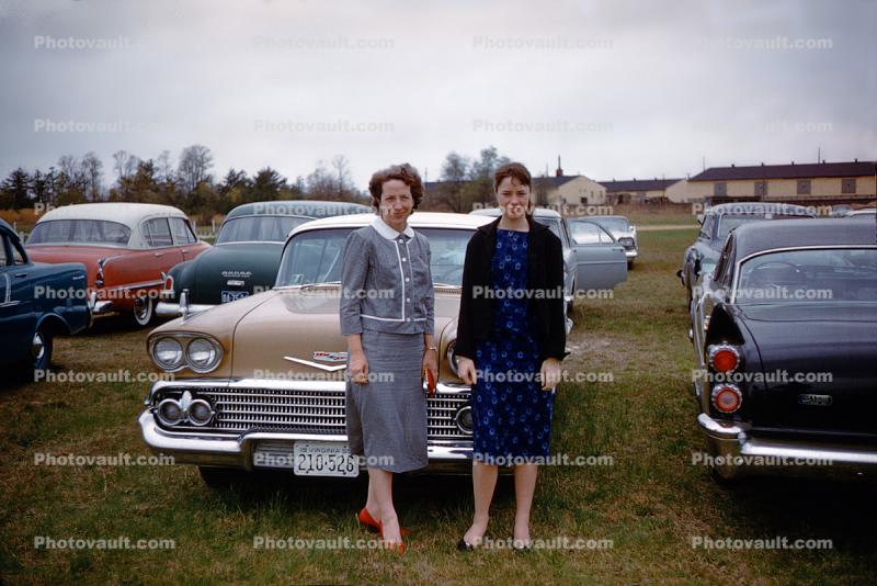 Women in front of a Chevy, car, 1959, 1950s