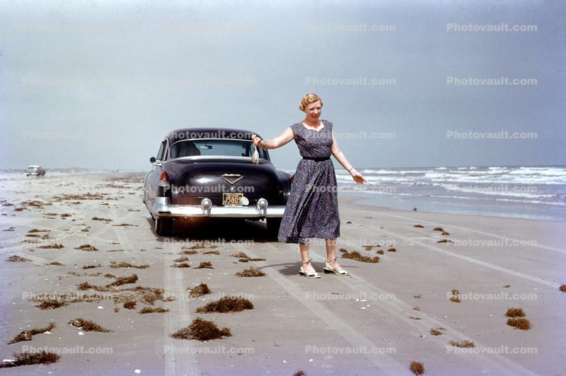Woman on the Beach, 1956 Cadillac De Ville, Sand, Dress, 1950s
