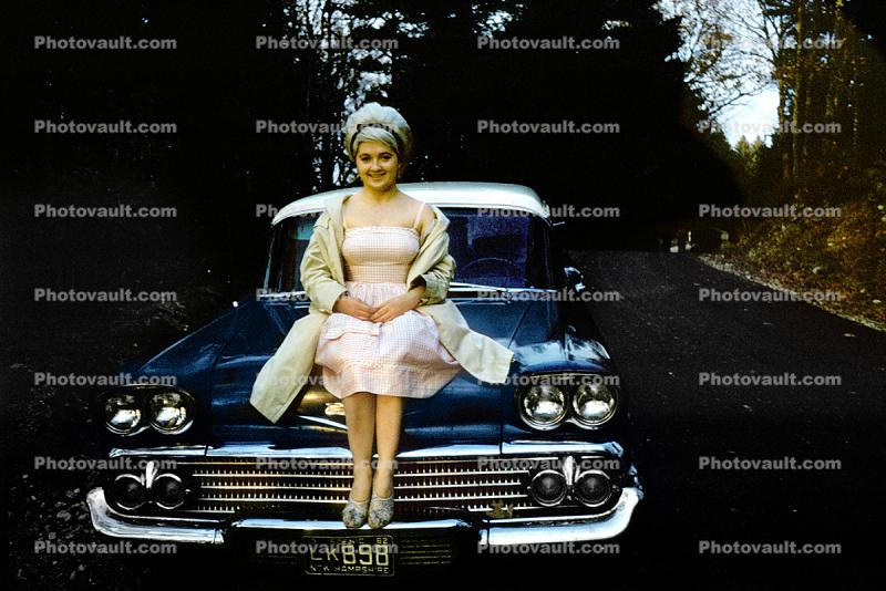 Woman sitting on the hood of a 1958 Chevy Nomad, Station Wagon, 1959, 1950s