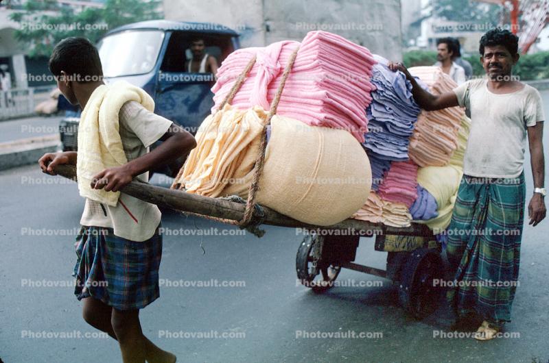 Men, Pulling a Cart, pushing, on the Streets of Mumbai
