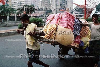 Men, Pulling a laundry Cart, pushing, on the Streets of Mumbai