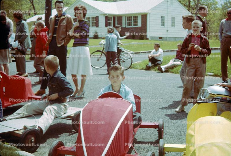 Boy in his Downhill Racer, Soap Box Derby, suburbia, 1950s