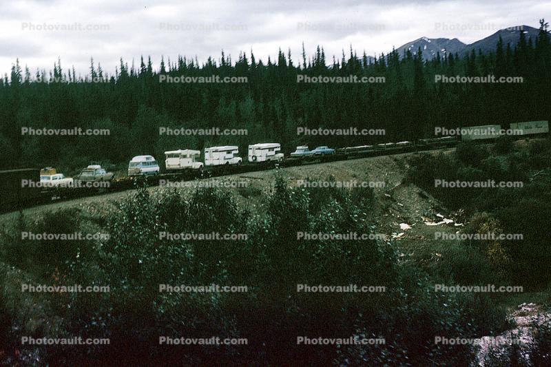 Caravan of RV's, on a train, near Skagway Alaska, August 1969