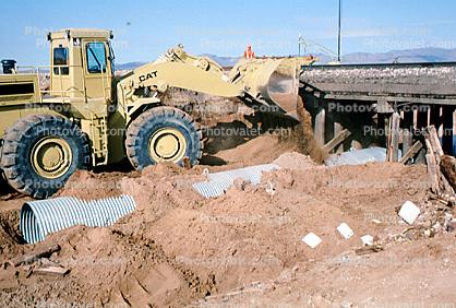 Articulated Front Loader, Train accident near Kingman, Arizona, caused by flash flooding, daytime, daylight