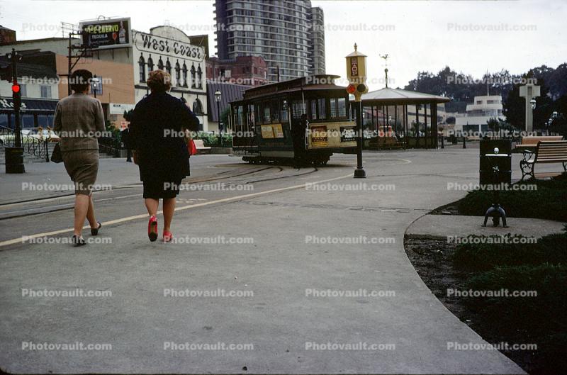 Woman waking, Cable Car Turnaround, stores, buildings, Hyde Street, February 1968, 1960s