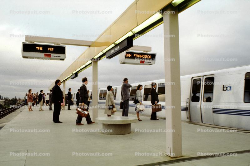 Passengers boarding a BART train, Bay Area Rapid Transit, platform, station, commuters