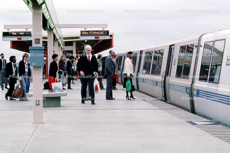 Passengers boarding a BART train, people, station, platform, commuters