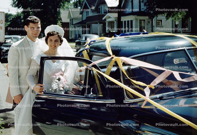 Wedding Couple enters Car, Suburbia,  1950s