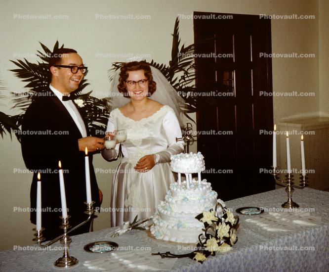 Groom and Bride ready to cut cake, 1960s