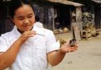 Chinese Woman holding a pet Bird