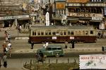 Trolley, cars, buildings, billboards, 1950s
