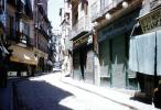 Cobblestone Street, sidewalk, buildings, shops, narrow street, 1940s, CEOV03P08_04