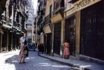 Cobblestone Street, woman, sidewalk, buildings, shops, narrow street, 1940s, CEOV03P08_05