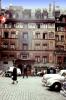 Hotel Des Balances, Hotel Waage, building, cars, people, wall paintings, cobblestone street, Lucerne, Switzerland, 1950s