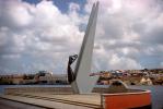 Curacao Monument to Victims of WWII, female sculpture, clouds, harbor, Willemstad, CIAV01P02_06