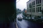road, highway, shops, stores, buildings, cars, rain, rainy, Harry Race Drugs store, automobile, vehicles, 1970s