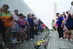 Vietnam Veterans Memorial, people, flowers, reflection