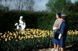 Gardens, flowers, path, people, statue, women, tulips, fur coat, shawl, hats, gloves, 1940s, COVV03P03_17
