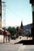 woman with child, street, church, buildings, Virginia City, 1960s