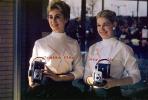 Pretty ladies holding a Polaroid Camera, 1950s, EIPV01P01_17