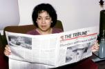 Woman Reading the Oakland Tribune Newpaper, ENCV01P03_16