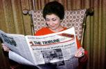 Woman Reading the Oakland Tribune Newpaper