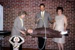 Floating girl through a hoop, brick wall, man woman, magician, magic, 1960s, ETHV01P04_15