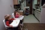Toddlers Eating on a High Chair