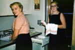 Women Washing the dishes, cleaning, drying cloth, towel, drawer, sink, silverware, 1950s