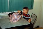Boy Stuffs a Turkey for Thanksgiving, Table, 1950s