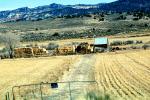 Hay Bale Stacks, Shack, Shed, barn, mountains, dirt road, path, gate, fence