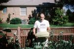 Man and his Squash Harvest, garden, fence, suburbia, house, home, building, lawn, FMNV08P11_09
