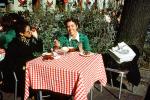 Table, Woman, Smiles, Checkerboard Tablecloth, Exterior, Outside, Outdoors, March 1975, FRBV09P02_04