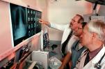 Doctors Looking at X-Ray, light box, Woman, Men, HHPV01P13_01