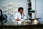 Female Doctor at her desk on the phone, HODV01P06_04