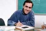 Man, smiles, classroom, chalkboard, books