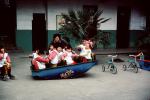 Rocking the boat, Teeter-totter, Tricycle, Girls, Boys, Wuxi, Shiangsi, China, 1950s, KEDV01P01_02