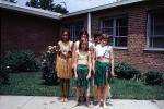 Girls, Grass Skirts, Lawn, Brick Building, Hawaii Day, smiles, smiling, 1960s, KEDV04P04_06