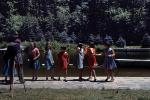 Schoolkids marching, lake