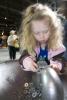 Girl playing with Magnets, hands-on exhibit, touch