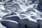 Mounds of Powdered Snow on Boulders
