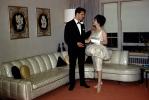 Man and Woman, Sofa with plastic cover, bizarre dress, gloves, formal, 1960s, PARV11P13_07