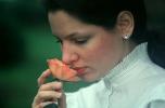 Woman Smelling a Rose with a slight smile, ears, skin, nose, lips, fingers, collar