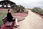 Woman sitting on a bench, Path, Pacific Grove, California, PBAV02P04_10
