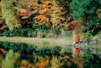 Woman sits over a Reflecting Pond, Fall Colors, New Hampshire, 1950s, autumn