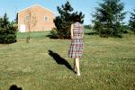 Woman Walking slowly, shadow, dress, lawn, Montreal, 1950s, PBAV02P10_15