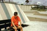 Man sitting on a bench, Daytona Beach, Florida, 1955, 1950s