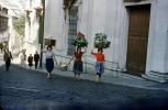 Women carrying vegetables, street, road, cobblestone, Lisbon, 1950s